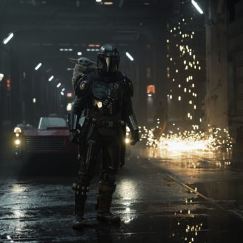 The Mandalorian stands in a dimly lit urban environment, with Grogu perched on his back, while sparks fly nearby, showcasing a tense but dynamic scene from the series.