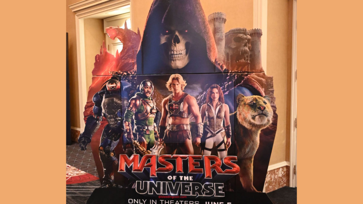A promotional standee for 'Masters of the Universe', featuring iconic characters like He-Man, Skeletor, and others, set against a vibrant backdrop.