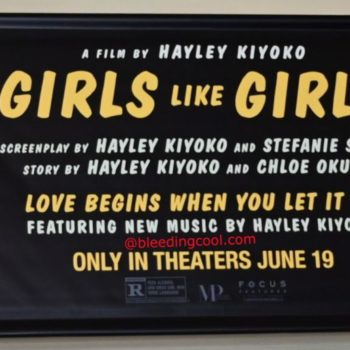 A promotional poster for the film 'Girls Like Girls,' featuring close-up images of two young women with water splashing around them. The poster includes text detailing the film's credits, a release date of June 19, and the tagline 'Love begins when you let it in.'
