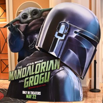 A large promotional standee featuring Grogu and the Mandalorian from Star Wars, displaying the title 'The Mandalorian and Grogu' with the text 'Only in theaters May 22.' Grogu is depicted with his signature large eyes and ears, while the Mandalorian's helmet is prominently showcased.