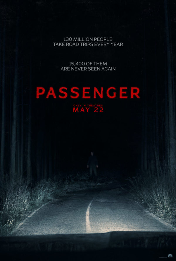A dark, eerie forest scene with a narrow, winding road illuminated by headlights. The title 'PASSENGER' is prominently displayed in bold red letters, along with an unsettling figure standing in the distance, hinting at a suspenseful theme.