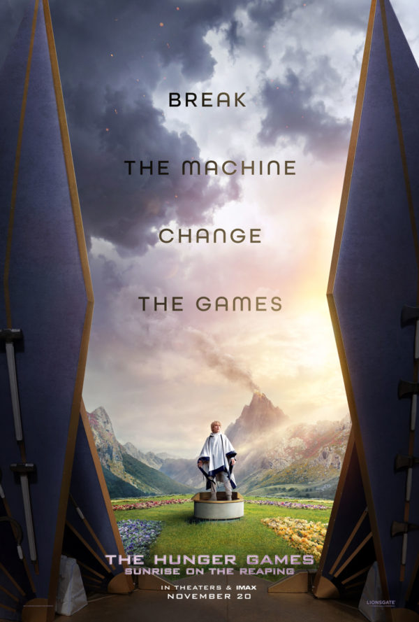 A movie poster for 'The Hunger Games: Sunrise on the Reaping' featuring a character standing on a circular platform in a vibrant landscape, surrounded by flowers and mountains. The text 'BREAK THE MACHINE CHANGE THE GAMES' is prominently displayed above, with release details at the bottom.
